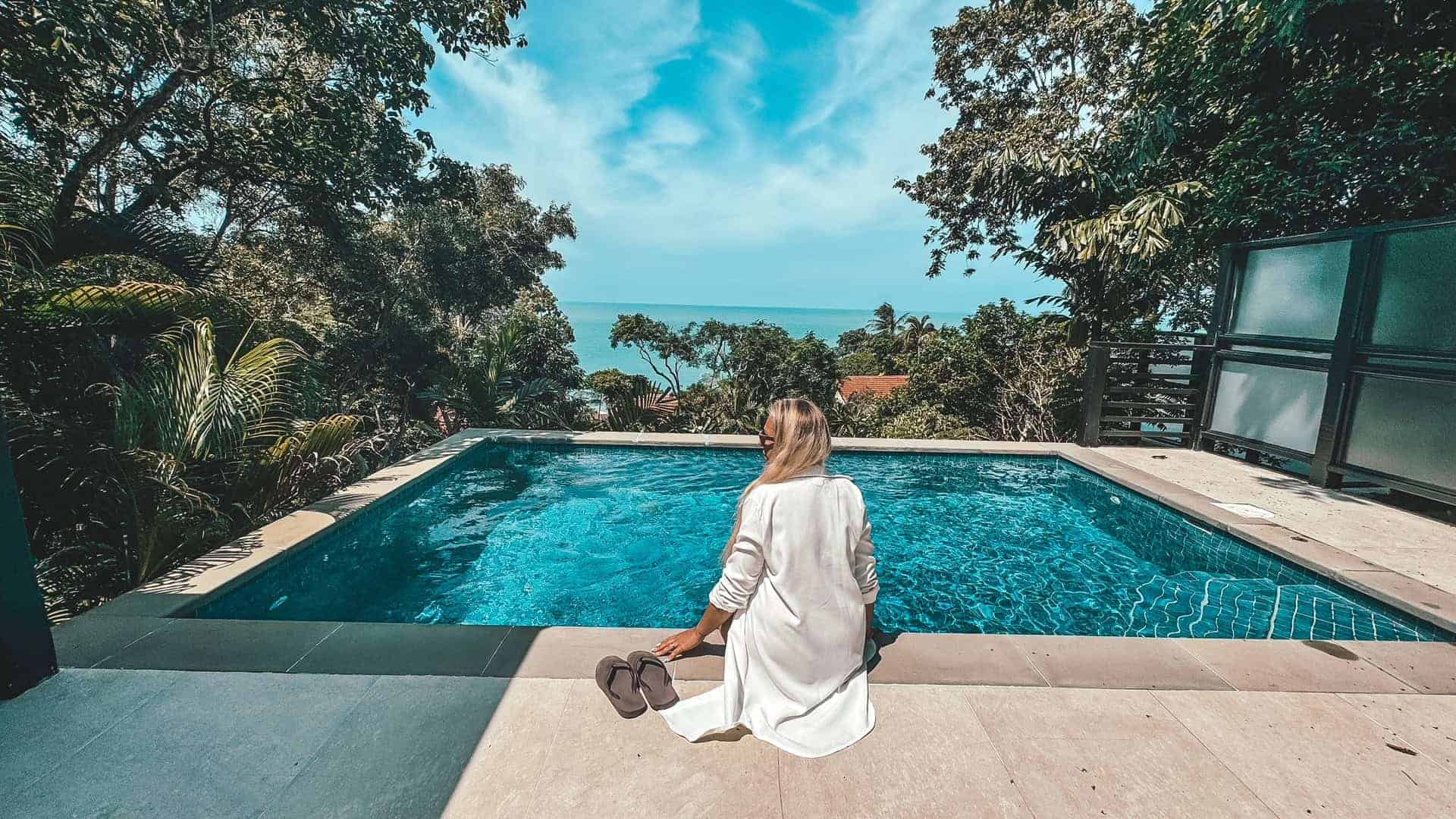 Luxury infinity pool overlooking lush tropical landscape in Koh Samui.
