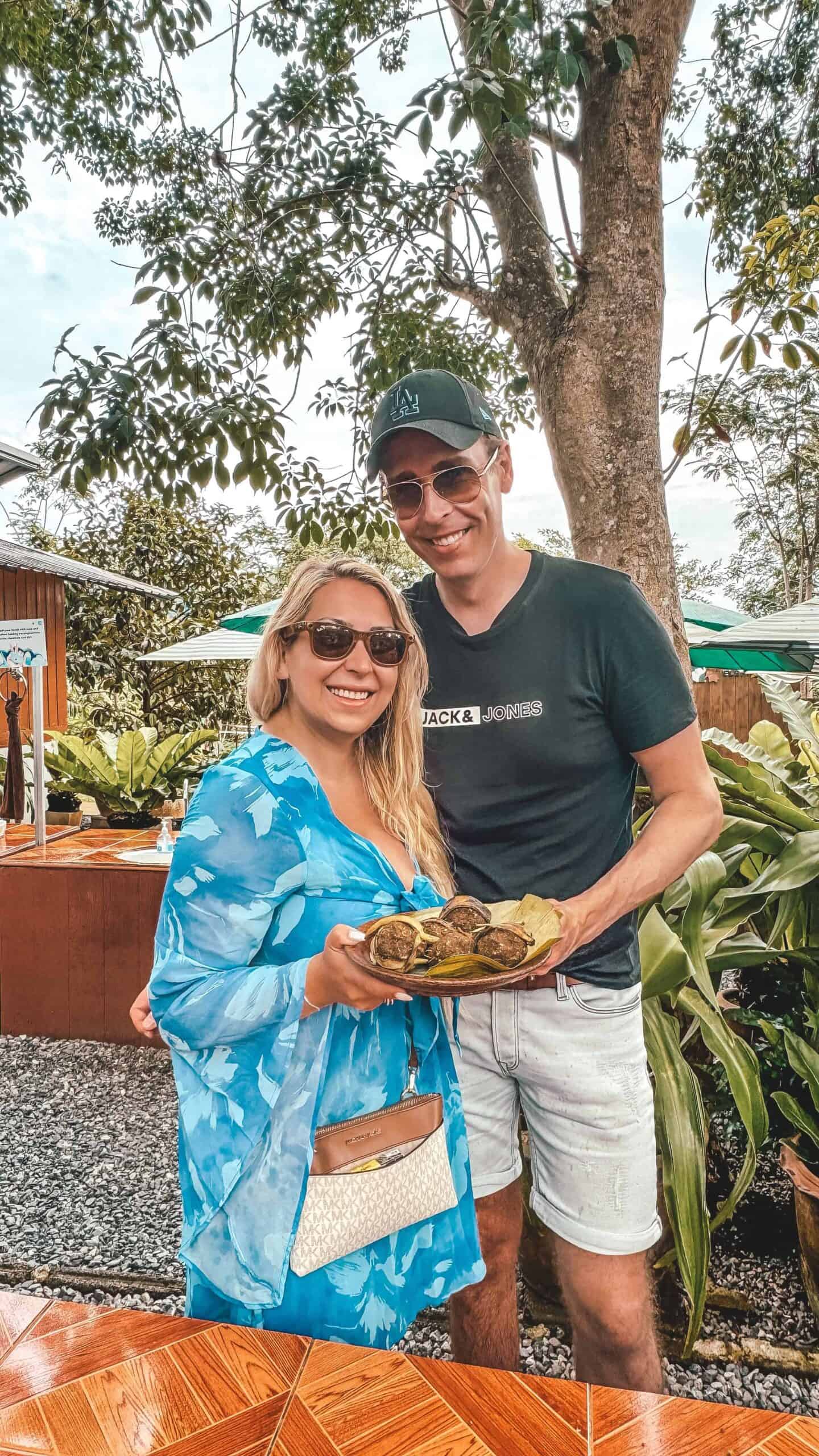 Happy couple enjoying a tropical outdoor meal in Samui, Thailand.