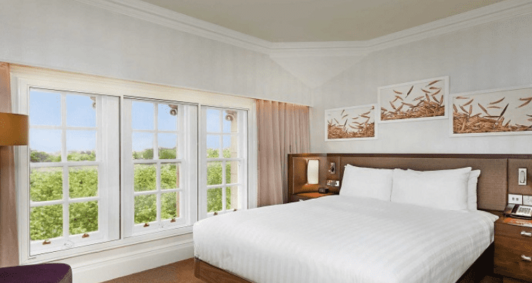 Bedroom with neatly arranged bedding, illustrating the 10-Point Healthy Home Checklist