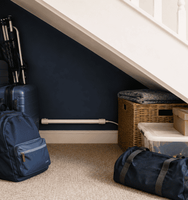Under-stair storage area with Damp Defender rod supporting moisture control in an enclosed space