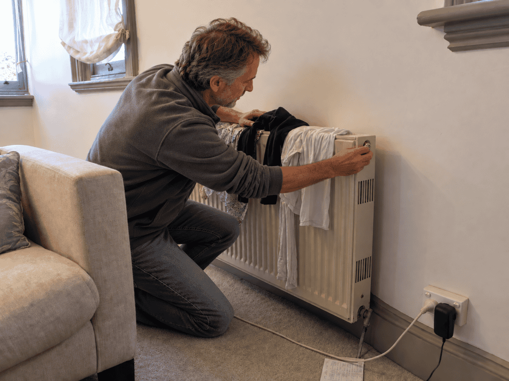 Person checking a household heater before cooler weather