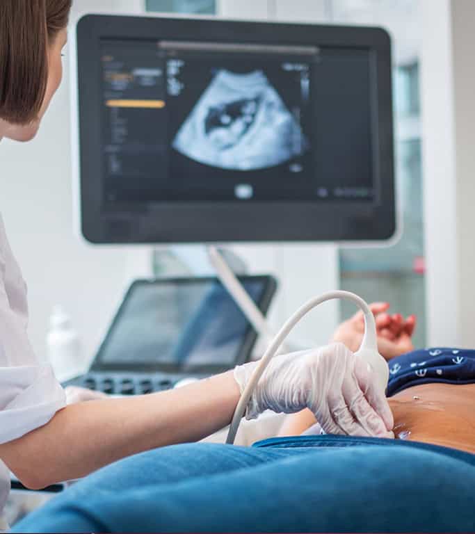 Medical professional performing transvaginal ultrasound for fertility assessment.