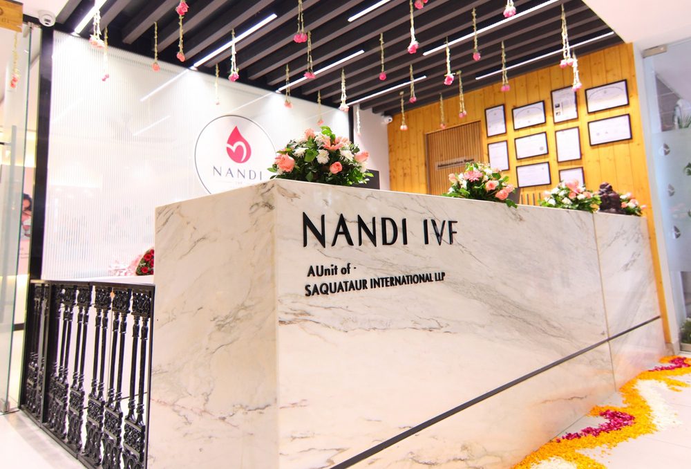 Nandi IVF clinic reception with marble counter and floral decor.