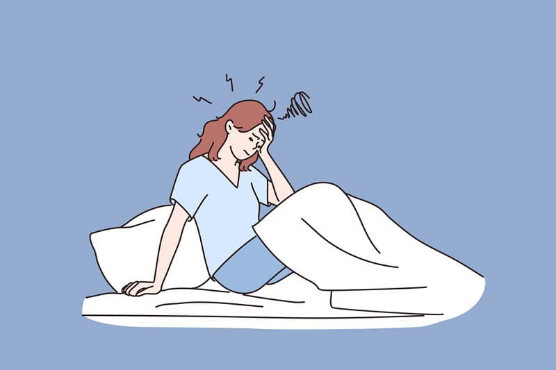 Woman experiencing discomfort after embryo transfer, illustrating common symptoms.