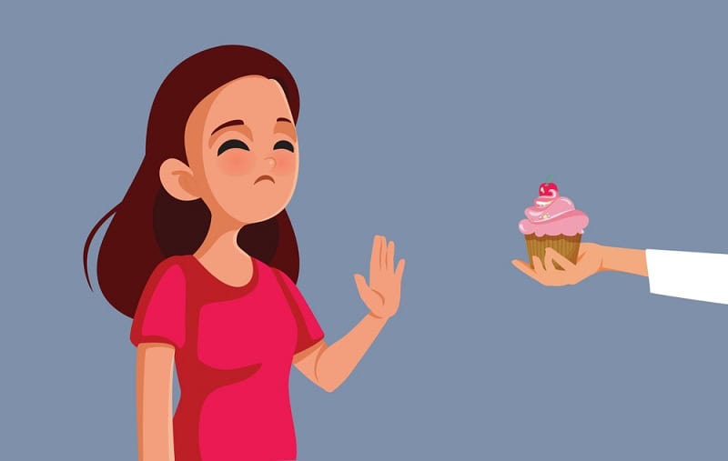 Woman refusing cupcake after embryo transfer at Nandi IVF clinic.