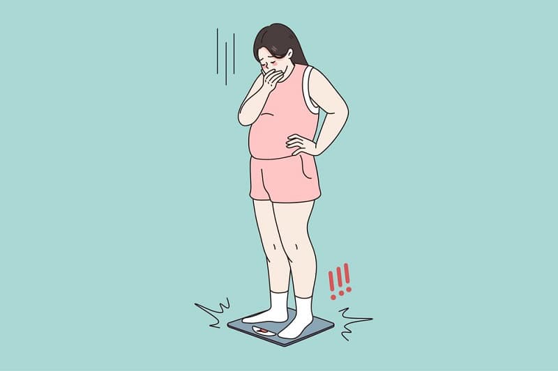 Woman feeling unwell after embryo transfer, weighing herself on a scale.