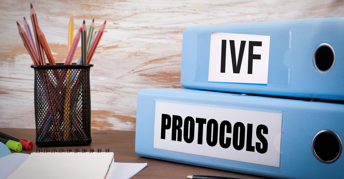 IVF protocols file folders on a desk for fertility treatment.
