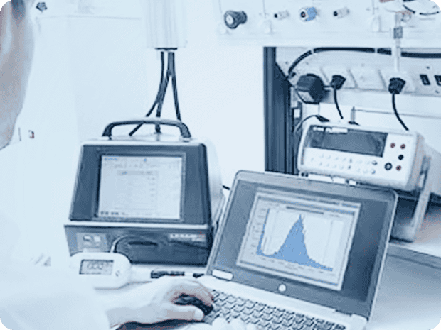 Microbial air sampler being used by a technician in a sterile pharmaceutical cleanroom environment.