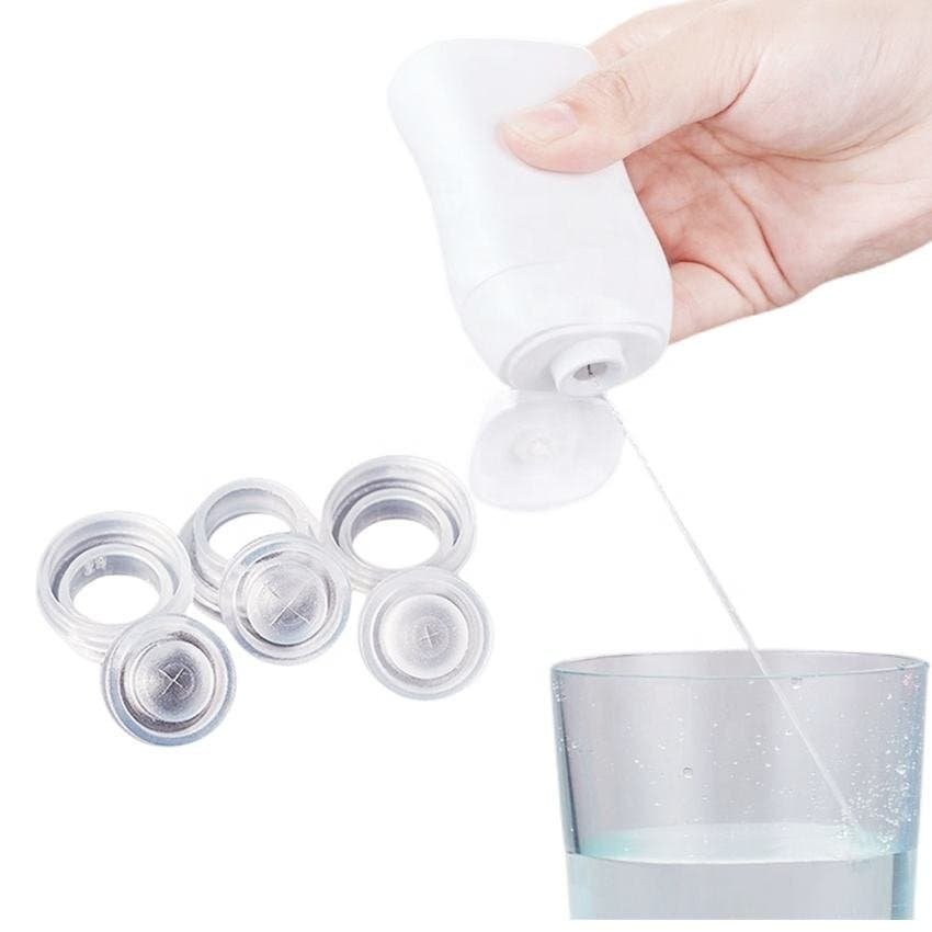 Hand holding a washing machine tablet dispenser, with several tablets and a glass of water, product for laundry or dishwashing, clean and modern design, hygiene, convenience, household cleaning essentials.