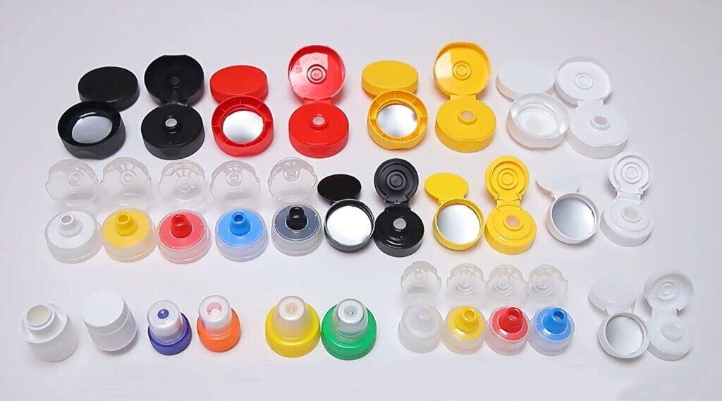 Capsule tops with integrated mirrors in various colors including black, white, red, yellow, blue, and green, used for medication packaging and easy identification.