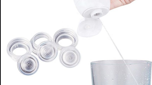 Silicone coffee pod lids with a hand pouring liquid into a glass, demonstrating eco-friendly reusable coffee accessories for sustainable coffee brewing.