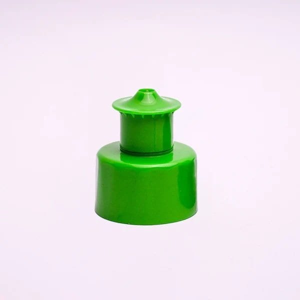 Green plastic device used for seed or fertilizer dispensing, commonly utilised in agricultural or gardening applications. Durable and lightweight, ideal for precise planting needs.