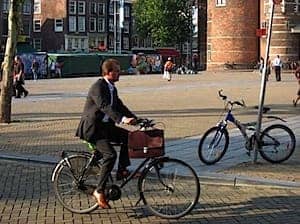 Another guy in a suit, this time with a briefcase - on a bicycle.

