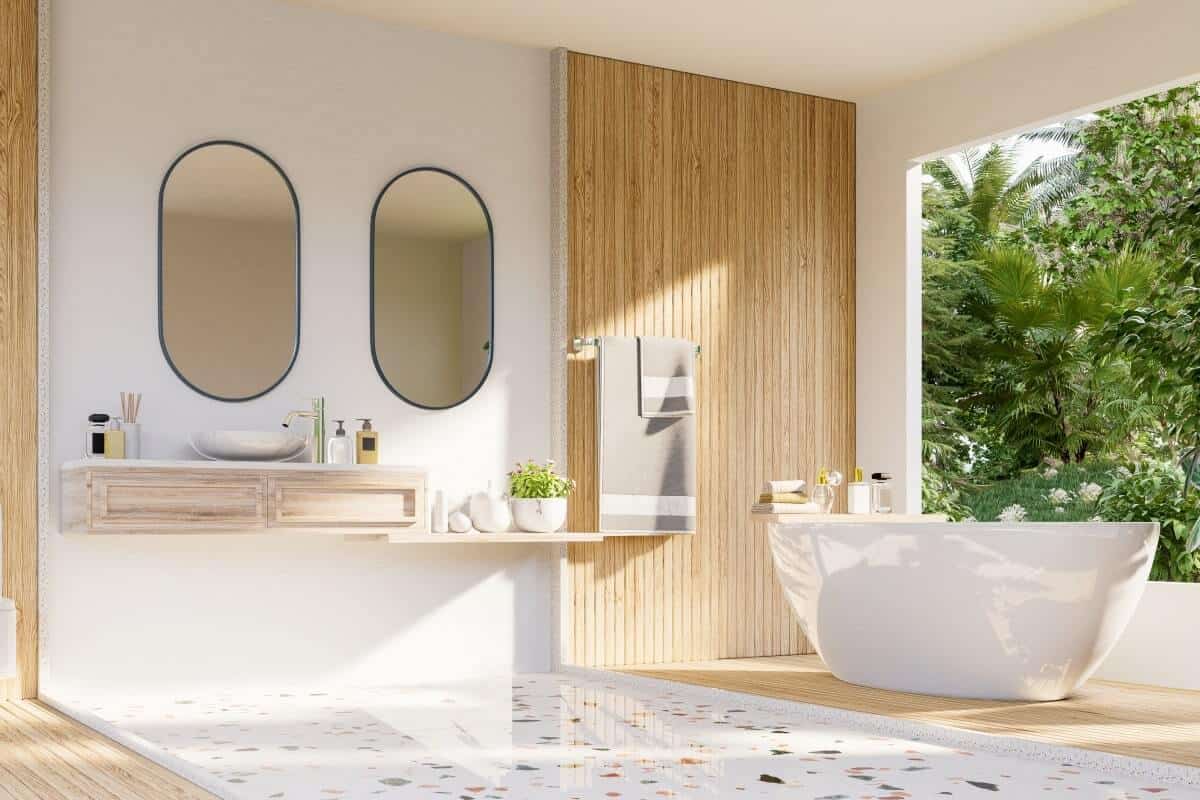 Elegant bathroom renovation featuring a stylish freestanding tub and natural light.