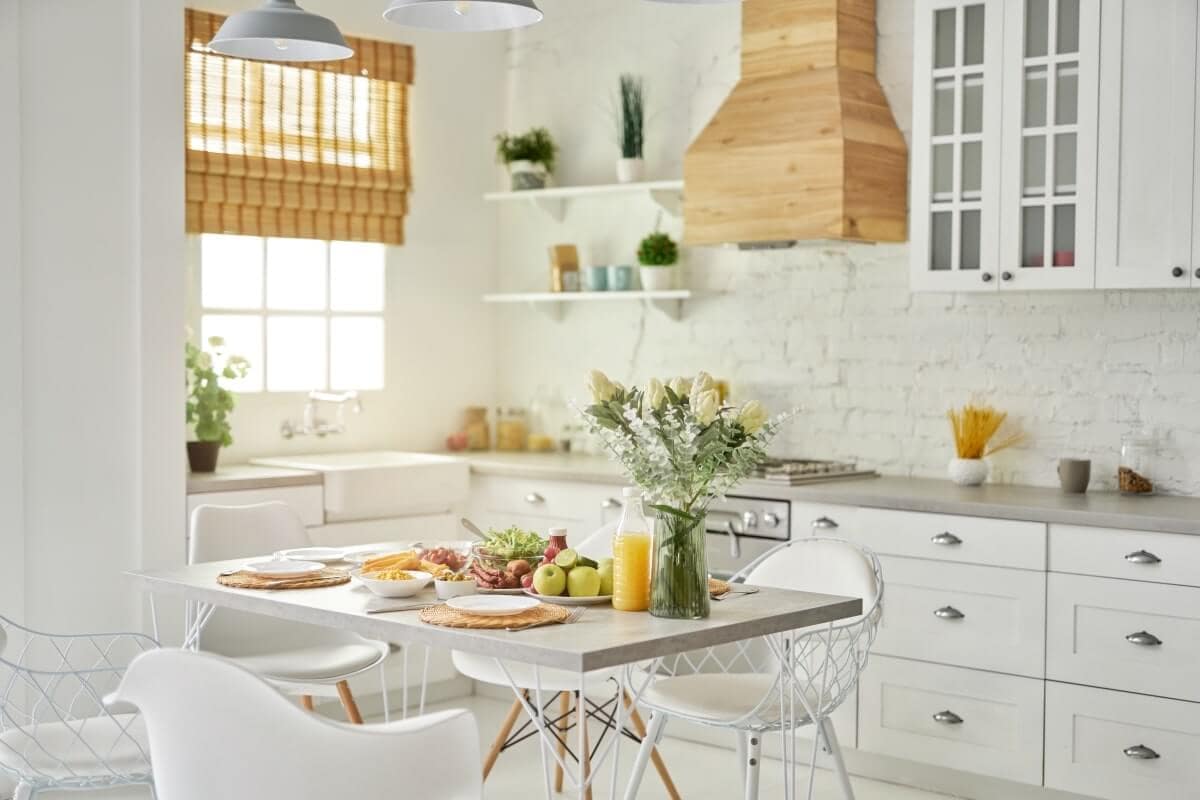 Fresh modern kitchen with white cabinets, wooden accents, and natural light, showcasing renovation