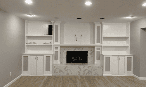 Elegant built-in white cabinets and a fireplace create a stylish, functional living space.