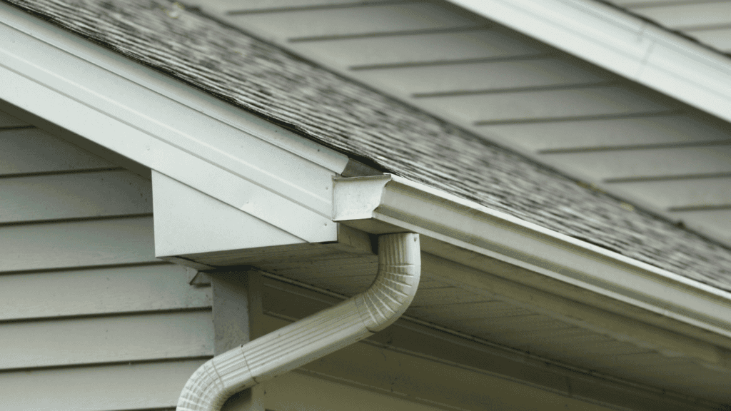 Roofing maintenance with clean gutters on a home