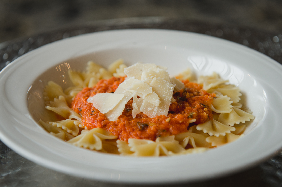Bowtie pasta topped with a chunky marinara sauce and shaved cheese.