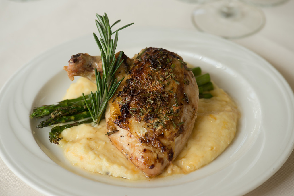 Roasted chicken breast with rosemary, served over mashed potatoes and asparagus.