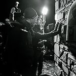 Damian Hall and Jack Scott touch the wall together at the finish of the 2023 Montane Spine Race.