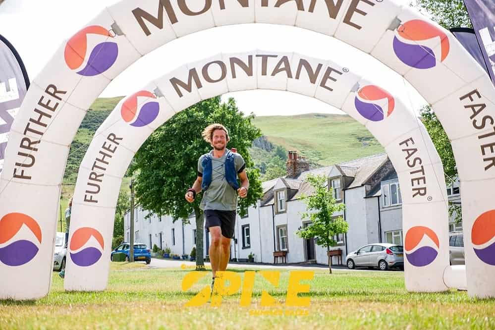 Dave Phillips crossing the finish line at the Montane Summer Spine 2023 Credit Will Roberts