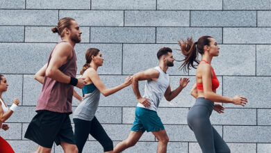 Group,Of,Young,People,In,Sports,Clothing,Running,Outdoors,Together