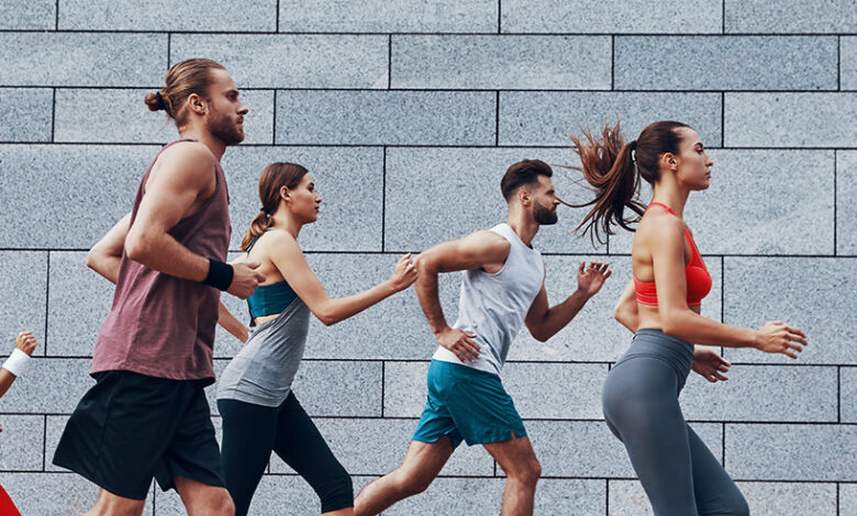 Group,Of,Young,People,In,Sports,Clothing,Running,Outdoors,Together