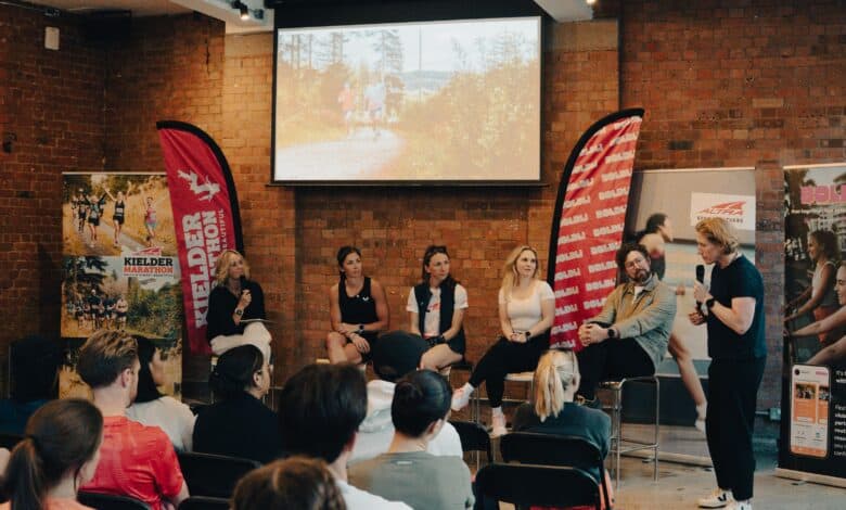 Engaging panel discussion at a running event, promoting marathon training, running tips, and athletic performance insights for passionate runners and enthusiasts.