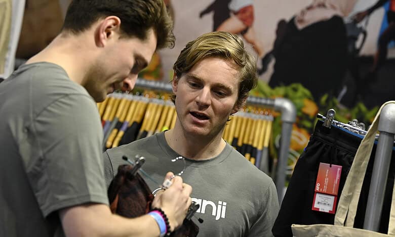 Running Insights, sportswear, and running shoes shop, focusing on running gear and accessories, with two male customers discussing gear in the store.