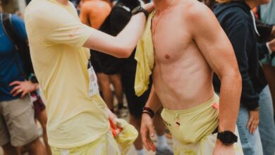 A young runner is showing support and camaraderie at a race event, highlighting sportsmanship and the emotional moments experienced by runners.