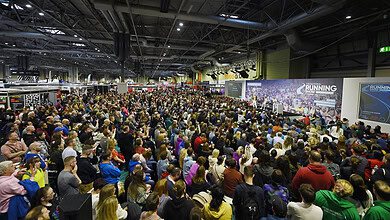 Vast crowd attending the Running Insights stage at the Birmingham Running Show, with speakers and presentations, dedicated to running enthusiasts and empowering runners with expert insights and the latest nutrition tips.