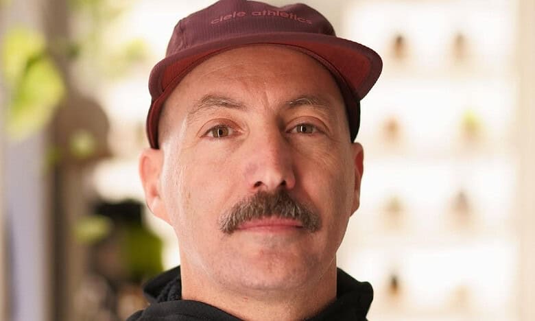 1. Portrait of a middle-aged man in running gear, showcasing dedication to running and fitness, indoors with natural lighting and blurred background.