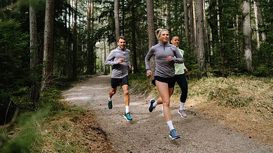 1. Group of diverse runners jogging through a forest trail, promoting outdoor running, fitness, and running insights for athletes.