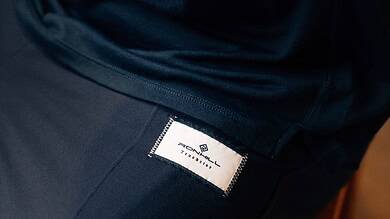 1. Close-up of Running Insights technical running apparel, highlighting performance fabric and brand label designed for serious runners and sports enthusiasts.