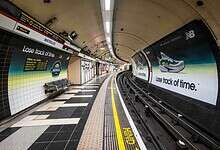 Modern New Balance sneaker displayed in Waterloo Tube station with an advertisement promoting "Lose track of time" for the running and footwear brand.
