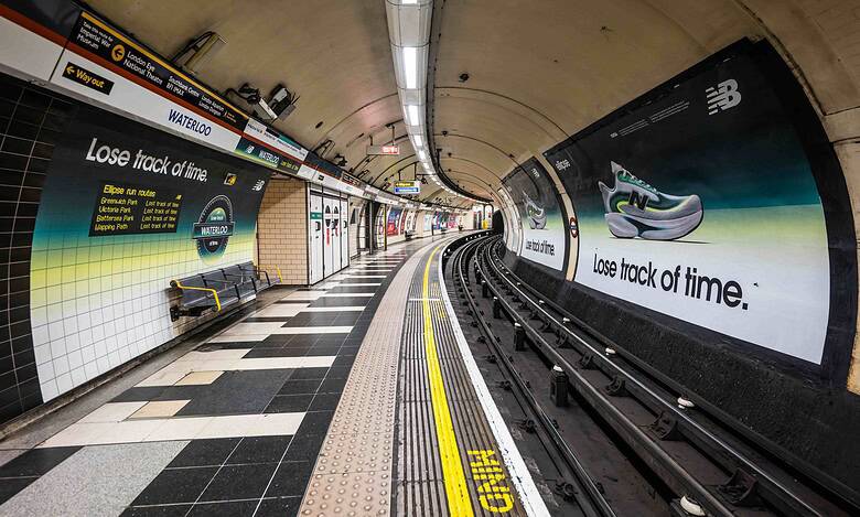 Modern New Balance sneaker displayed in Waterloo Tube station with an advertisement promoting "Lose track of time" for the running and footwear brand.