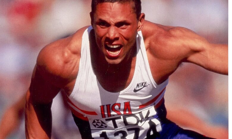 Athlete in mid-race sprint, showcasing explosive power and speed during a track event.