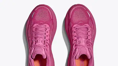 Pair of pink running shoes with breathable mesh upper and cushioned sole, ideal for running and athletic activities.