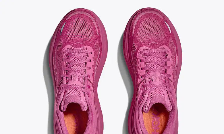 Pair of pink running shoes with breathable mesh upper and cushioned sole, ideal for running and athletic activities.