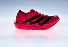 Close-up of the adidas Adizero Adios Pro 5 race day super shoe in vibrant red with black accents, designed for elite runners and featuring advanced cushioning technology.
