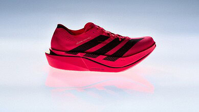 Close-up of the adidas Adizero Adios Pro 5 race day super shoe in vibrant red with black accents, designed for elite runners and featuring advanced cushioning technology.