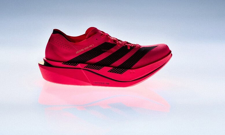 Close-up of the adidas Adizero Adios Pro 5 race day super shoe in vibrant red with black accents, designed for elite runners and featuring advanced cushioning technology.