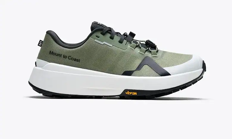 Green Mount to Coast running shoe with black and white accents, designed for trail running and outdoor activities.