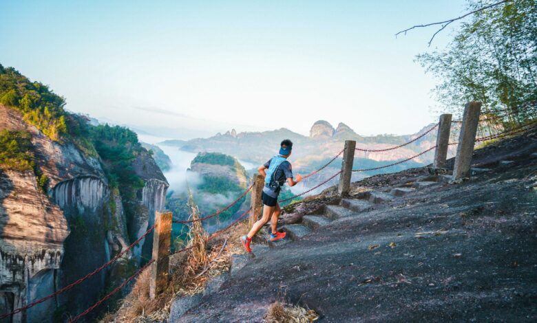 A trail runner crossing a mountain path above Wuyishan’s sandstone peaks