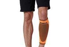 Orange Bearhug compression sleeve on a man's lower leg, knee to ankle, showing a dotted pattern and branding.