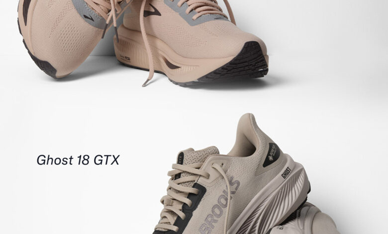 Pair of Brooks Ghost 18 GTX running shoes in beige and grey, showcasing their lightweight design and durable outsole, ideal for autumn running in wet conditions.