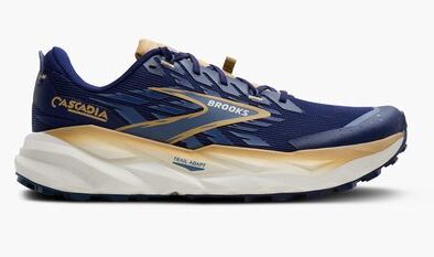 Brooks Cascadia trail running shoes in navy blue with beige and gold accents, designed for outdoor trail running and stability.