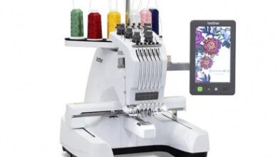 High-tech embroidery machine with multiple spools of thread and digital touchscreen interface for precise textile embroidery and design.