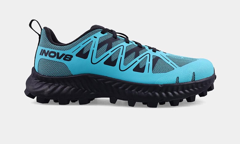 Blue INOV8 MUDTALON V2 women's trail running shoe with aggressive grip for muddy terrains.