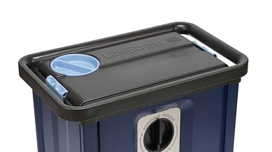 Blue and black portable waste or storage container with control knob and hose.